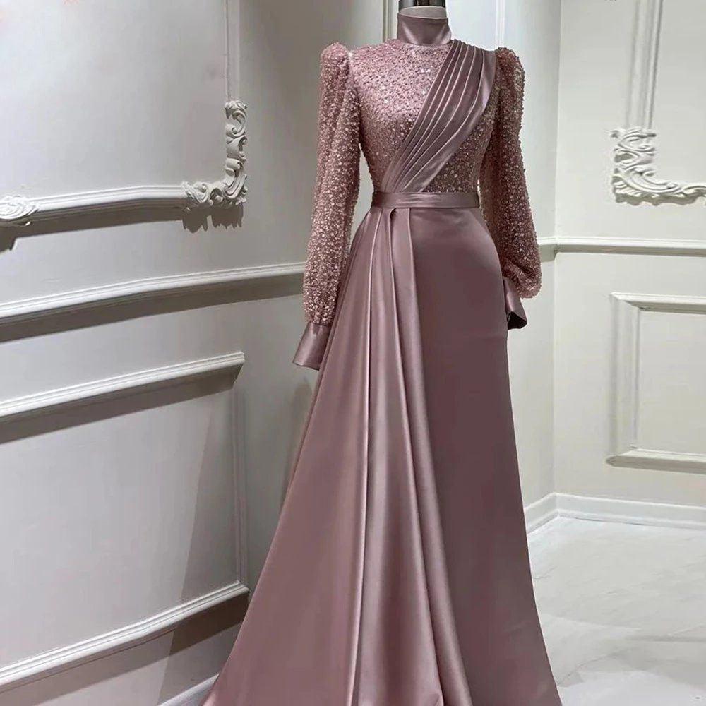 Dusty rose sequin long-sleeve evening dress with diagonal shoulder drape and pleated satin skirt