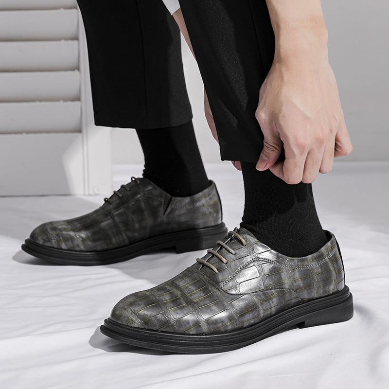 Dark gray leather lace-up dress shoes with textured pattern and low-profile sole
