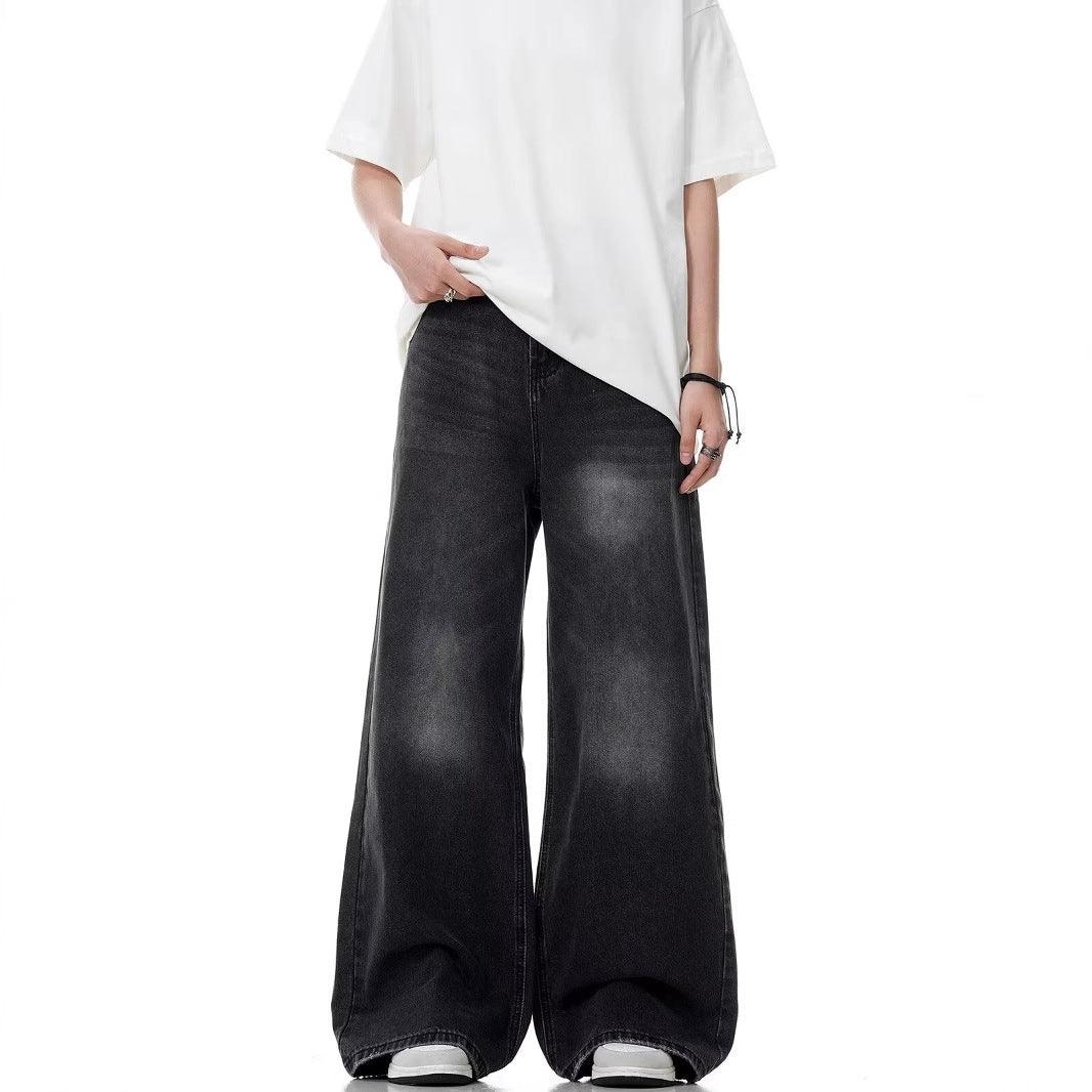 Washed black straight-leg jeans with distressed finish and wide flared cuffs