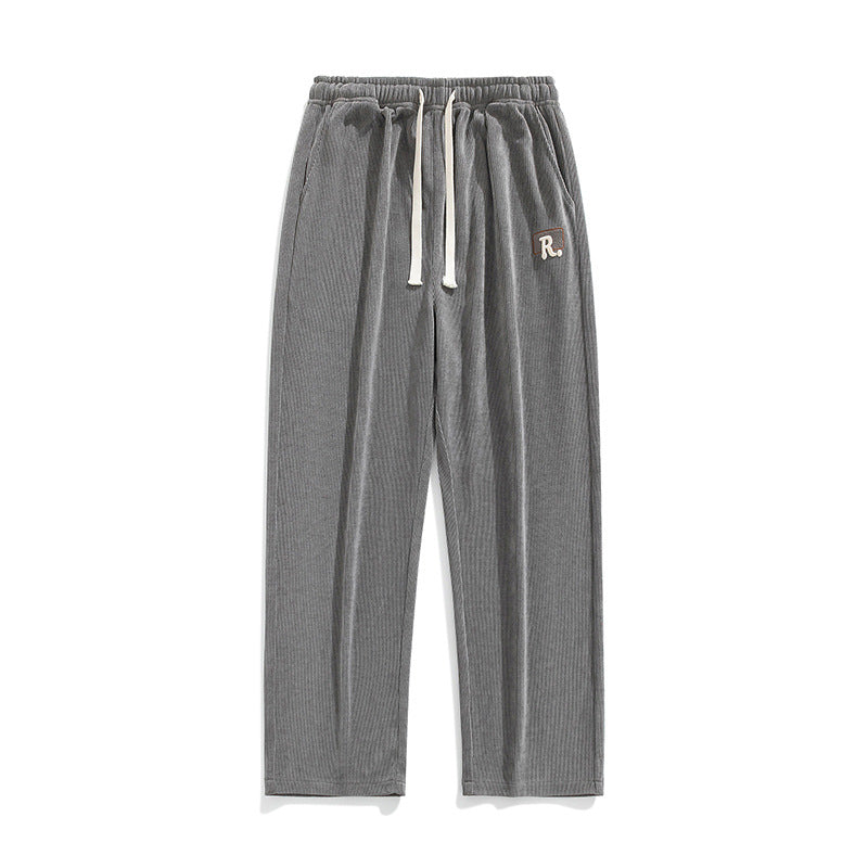 Men's draped casual pants, light gray with elastic waistband and drawstring ties, logo patch