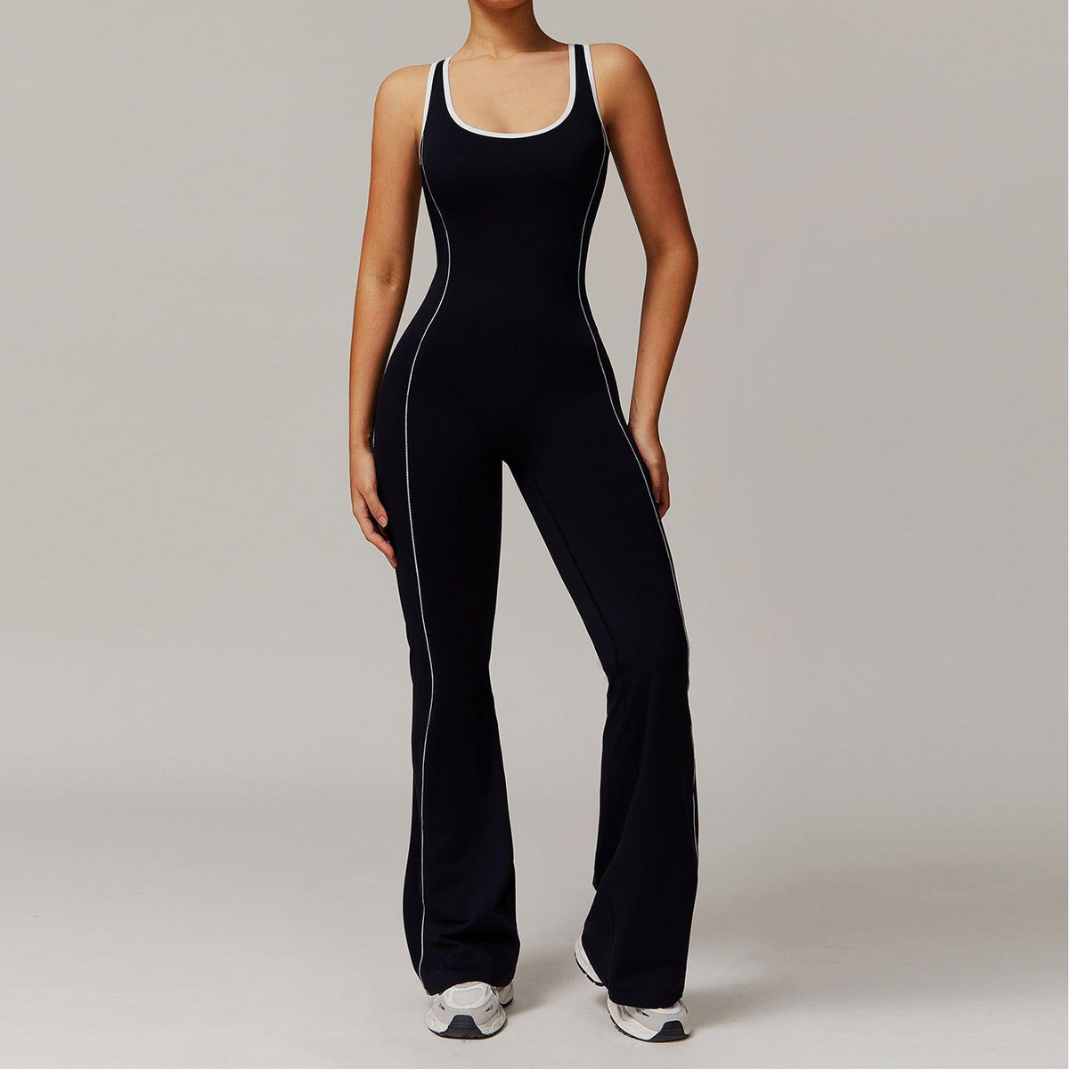 Black sleeveless yoga jumpsuit with contrast piping, scoop neck, flared straight legs