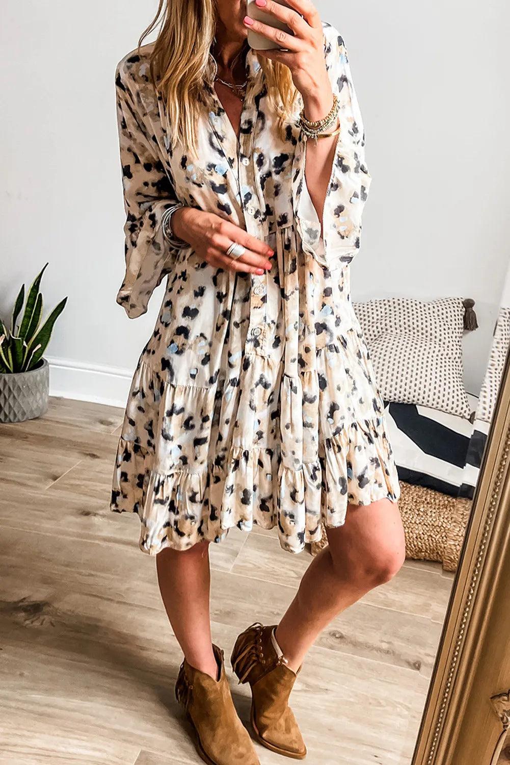 Women's button-front loose dress in cream with black and blue floral spots, tiered skirt