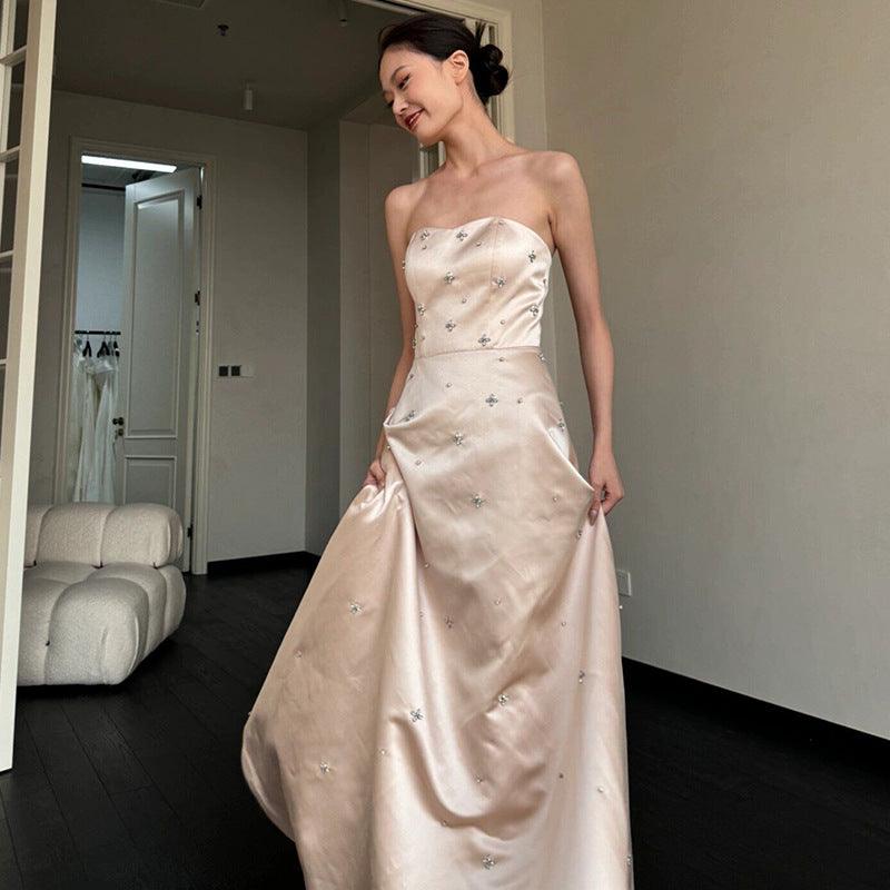 Champagne satin strapless wedding dress with sparkly star accents and full A-line skirt