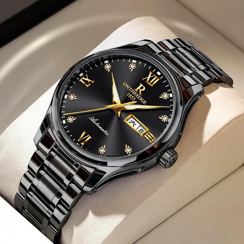 Black dial mechanical watch with gold hands and markers, silver metal bracelet, date