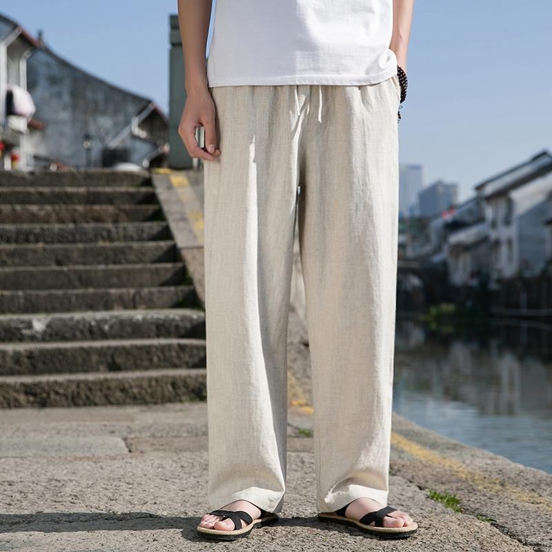 Loose cotton-linen trousers in light beige with straight wide legs and drawstring waist