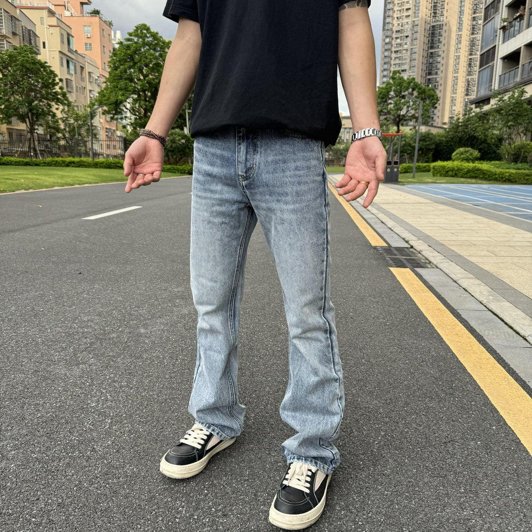 Men's light blue washed wide-leg jeans with zip fly and belt loops