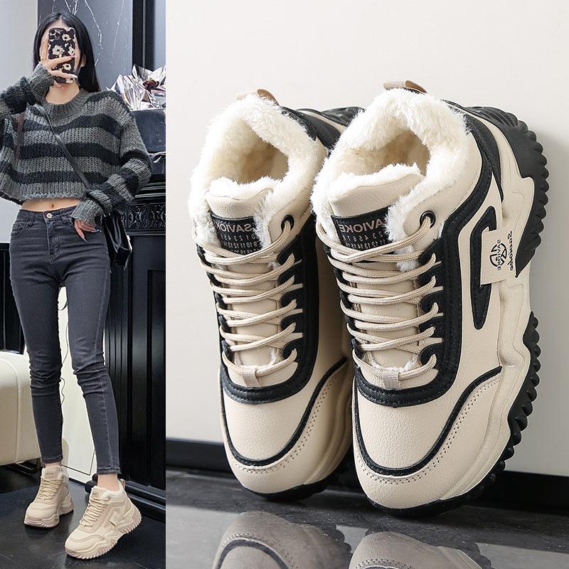 Fleece-lined chunky high-top sneakers, cream with black trim and thick lug sole.
