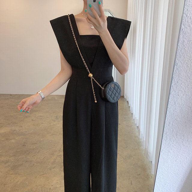 Black sleeveless V-neck jumpsuit with wide legs and fitted waist seam detail.