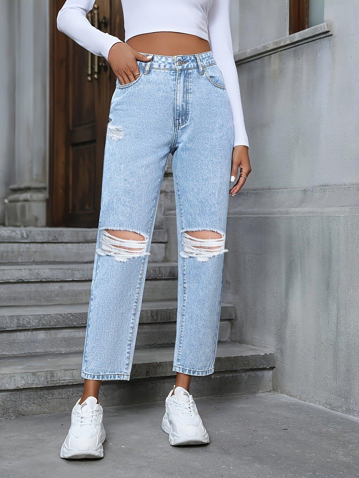 Light blue ripped straight denim trousers with frayed knee rips and cuffed hem