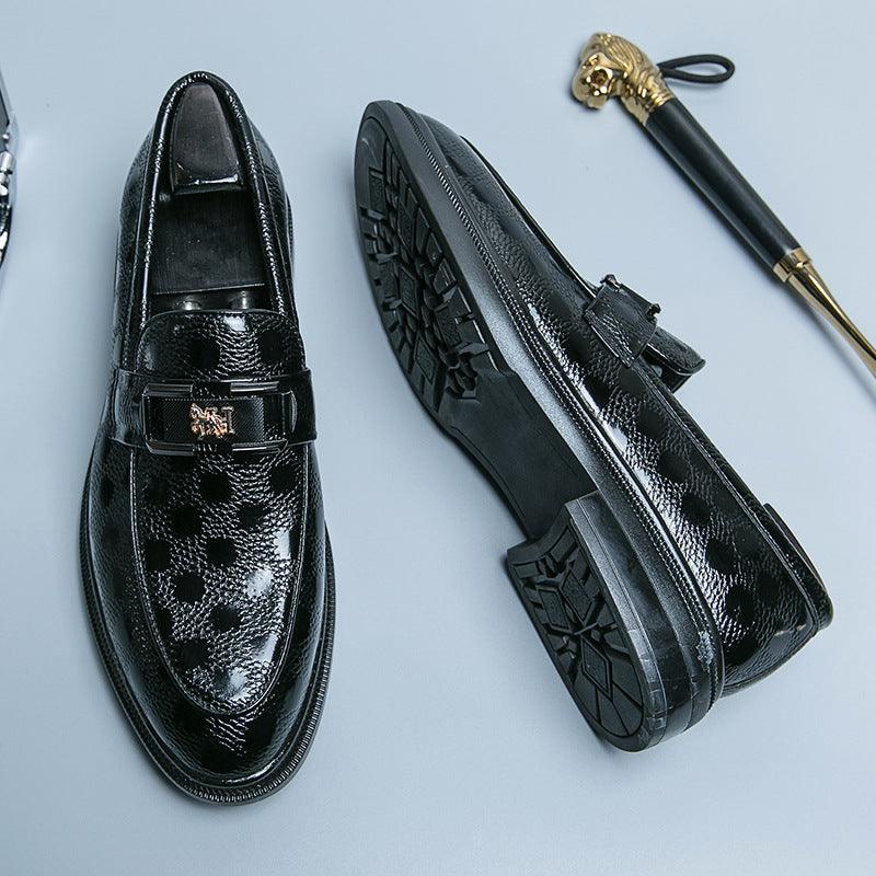 Black leather loafer shoes with buckle strap and patterned vamp, side view with treaded sole