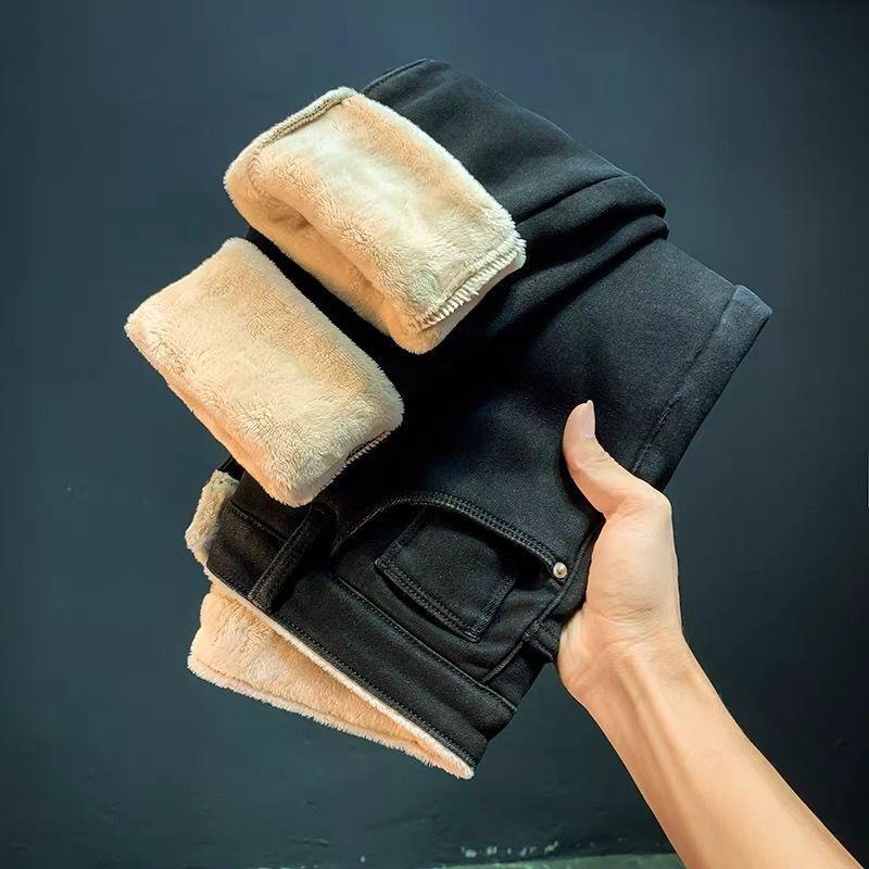 Fleece-lined high-waist slim-fit pants in black with tan plush sherpa cuffs