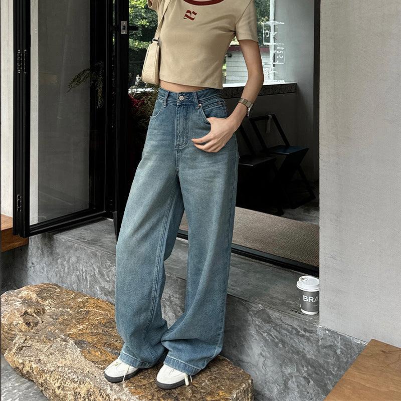 Light blue loose wide-leg denim jeans with front pleats and cuffed hems