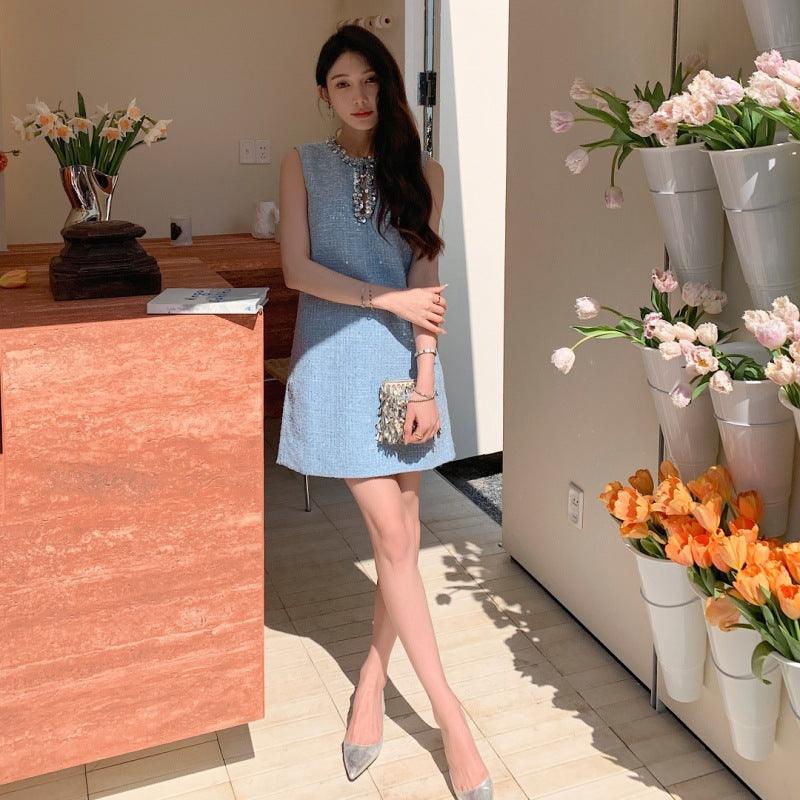 Blue sleeveless sequin dress with jeweled keyhole neckline, above-knee length