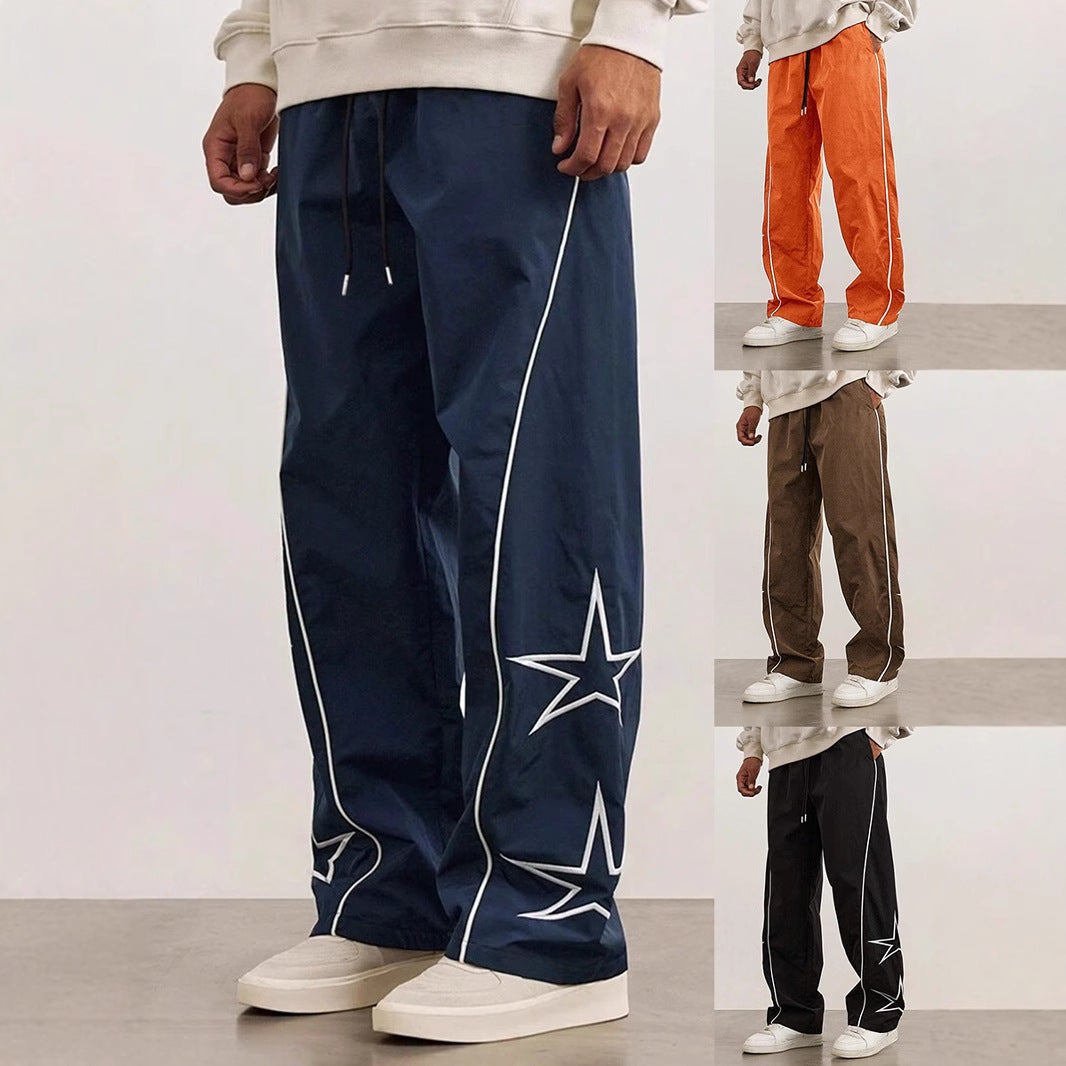 Navy blue wide-leg trousers with white piping and star embroidery on the legs