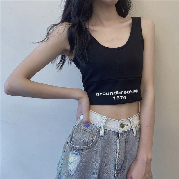 Black sleeveless crop vest top with “groundbreaking 1974” logo print