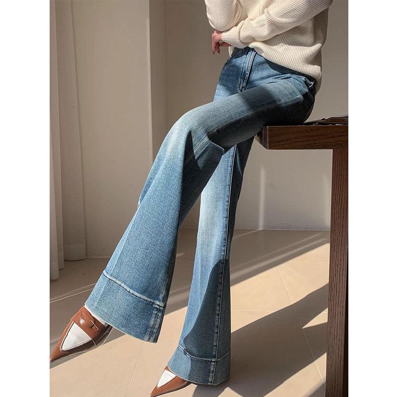 Blue washed wide-leg flare jeans with contrast stitching and front button closure