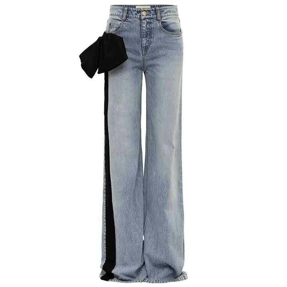 Light-wash denim jeans with wide legs and black side stripe, front button closure