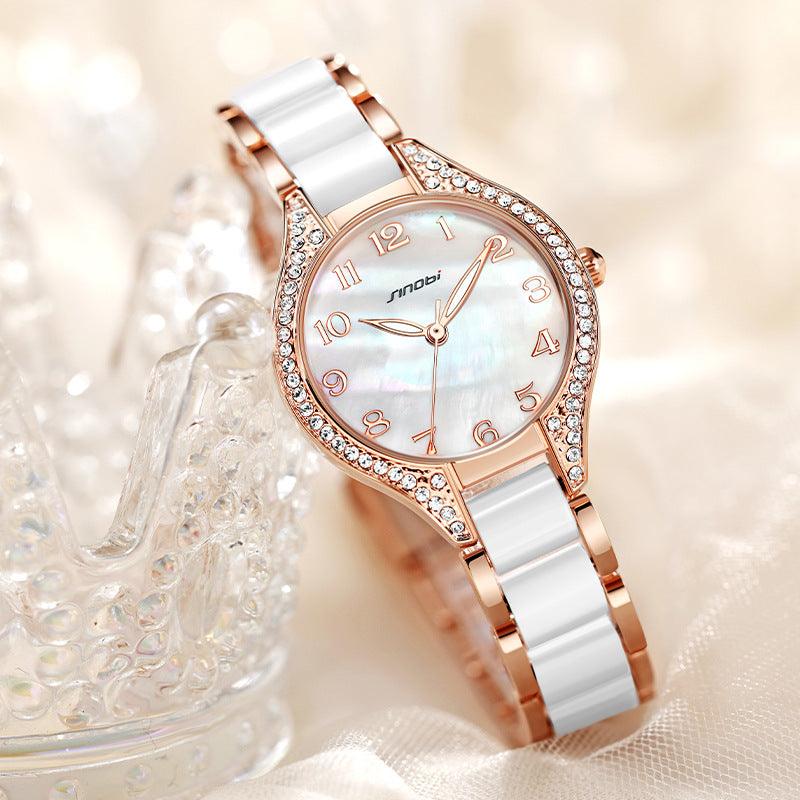 Two-tone wristwatch with rose-gold crystal bezel, white dial, metal link band