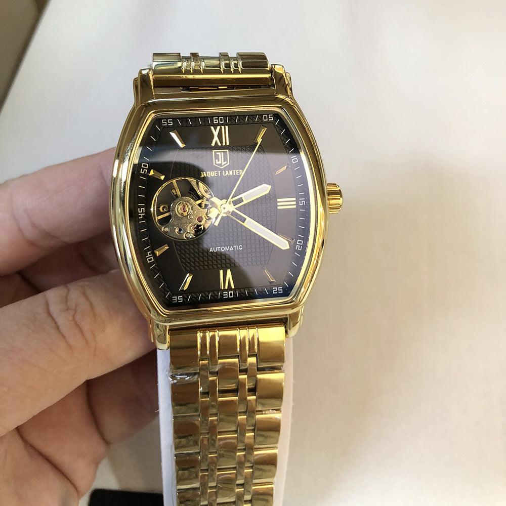 Square mechanical watch with gold-tone case, black dial, and gold metal bracelet.