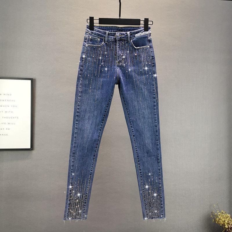 High-waist skinny jeans in blue denim with rhinestone speckles along legs