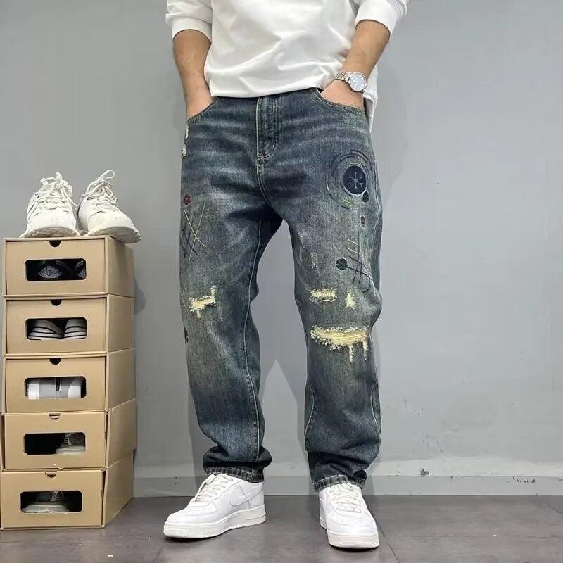 Men's straight jeans in dark blue with ripped knee patches and distressed print.