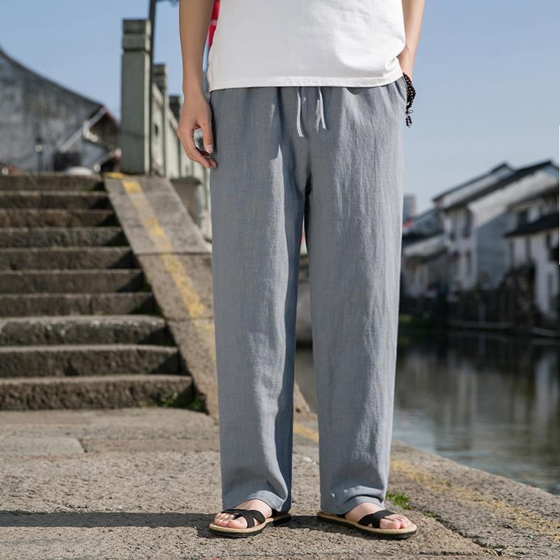 Loose cotton-linen trousers in light blue-gray with straight wide legs and drawstring waist