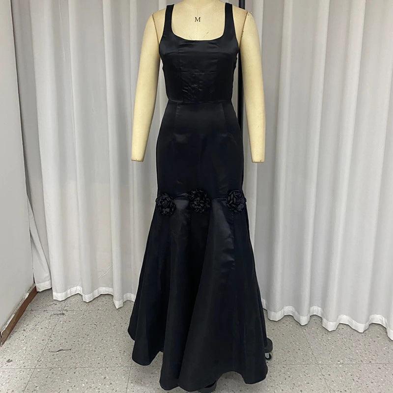Black halter maxi dress with 3D flower appliques on the lower skirt, sleeveless