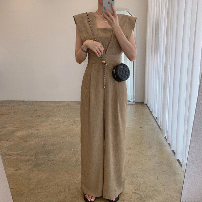 Khaki sleeveless V-neck jumpsuit with wide legs and fitted waist seam detail.