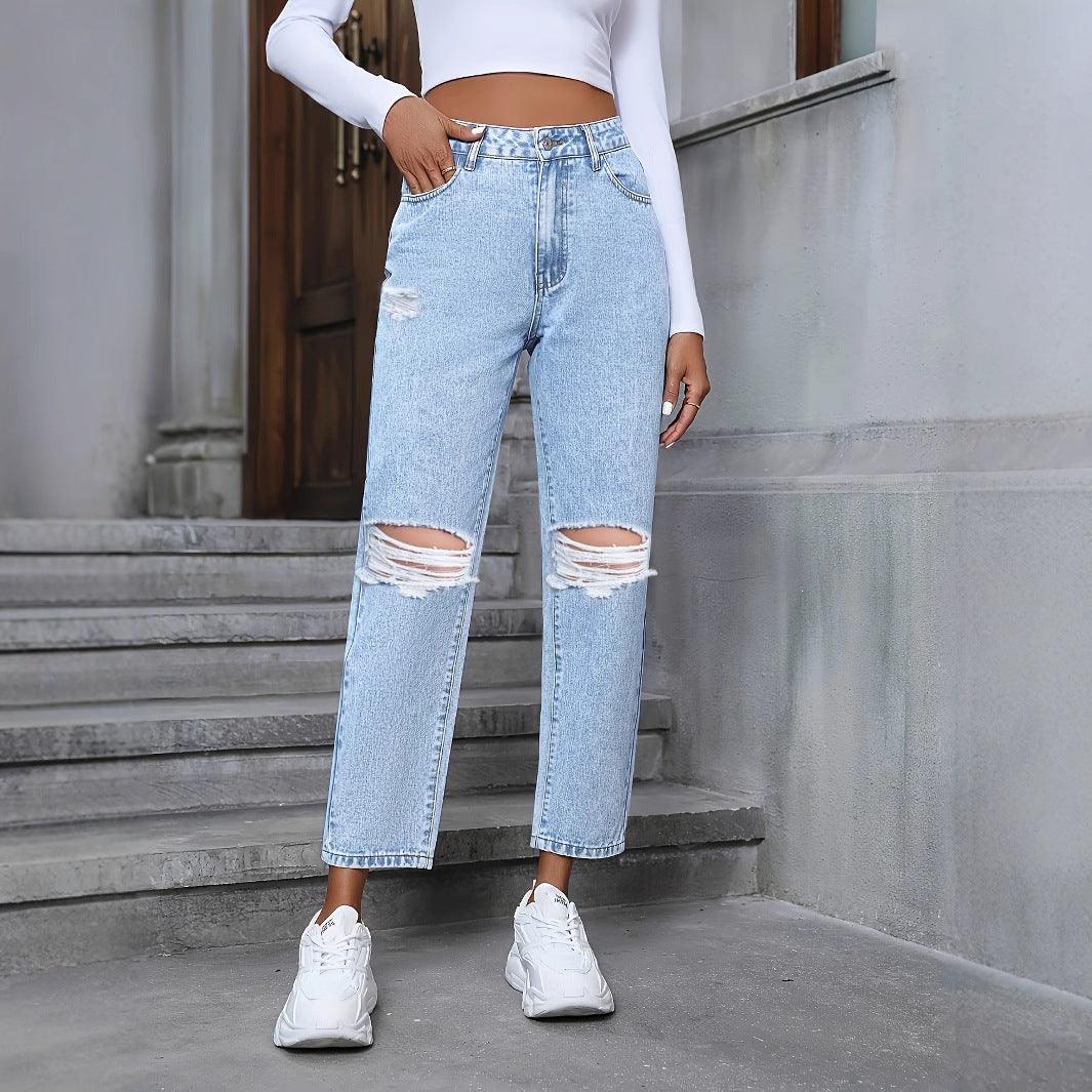 Light blue ripped straight-leg denim trousers with frayed knee rips and cuffed hem