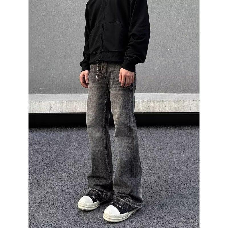 Men's slim-fit dark jeans with faded, worn look and distressed leg detailing