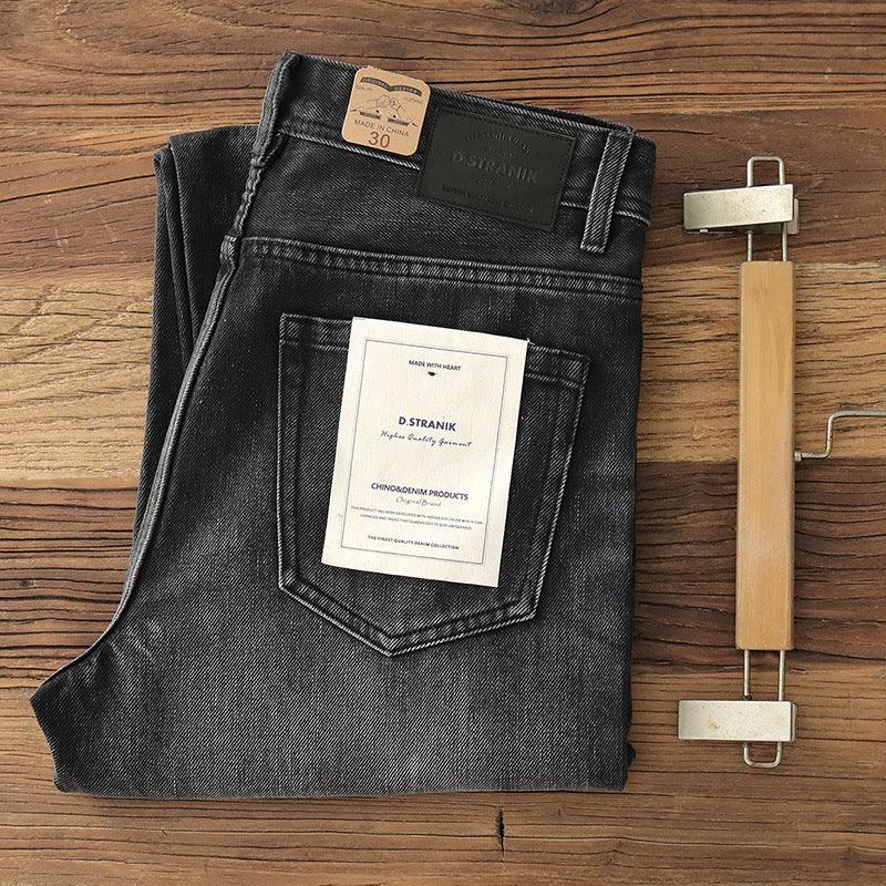 Men's black washed denim jeans folded with brand label and size tag