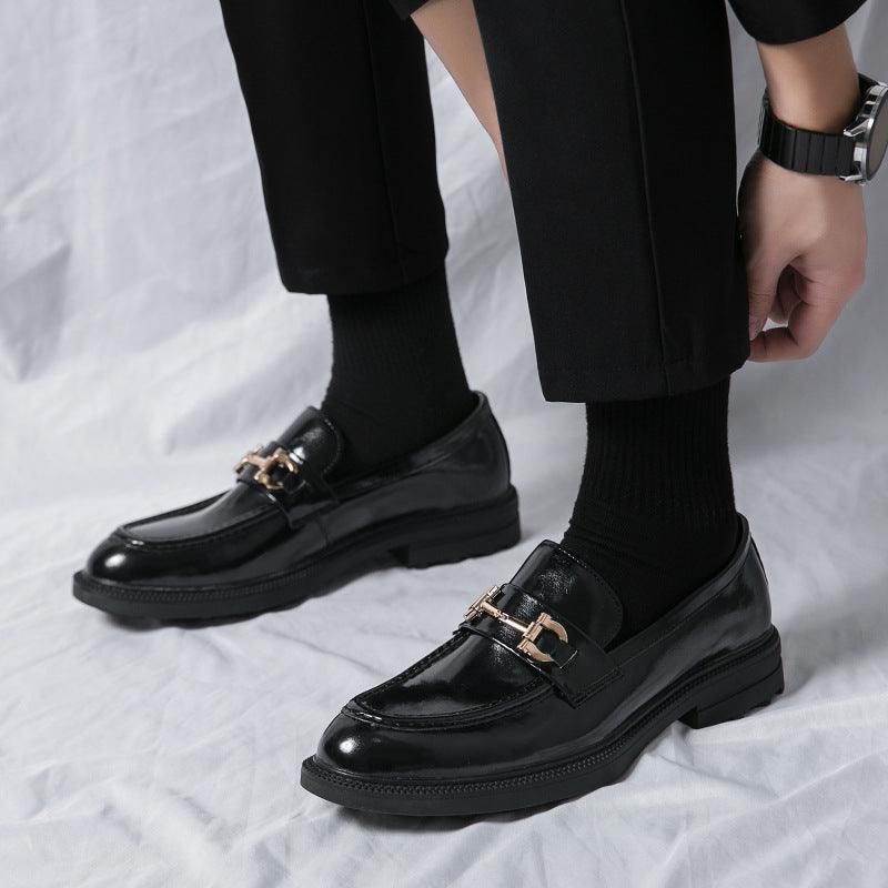 Men's black platform loafer with gold buckle strap and glossy finish, thick sole.