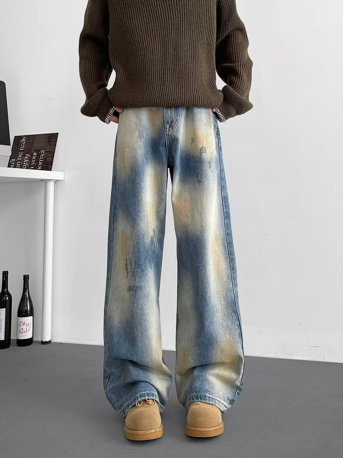 Light blue washed wide-leg jeans with distressed panels and cuffed hem