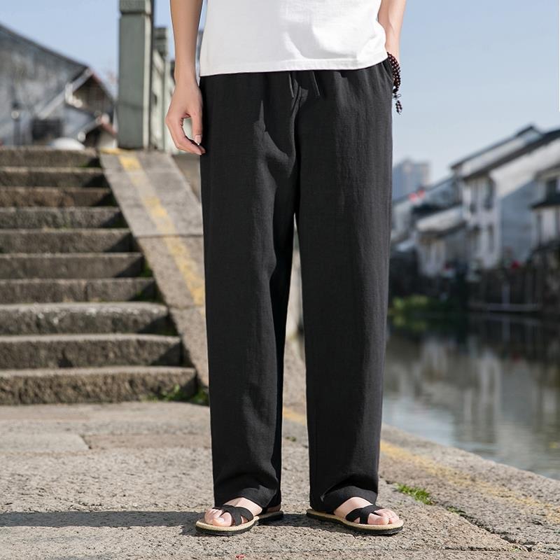 Loose cotton-linen trousers in black with straight wide legs and drawstring waist