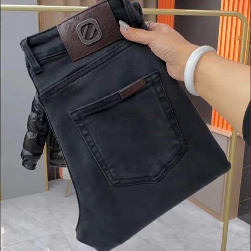 Men's black slim-fit jeans with leather brand patch and front pockets