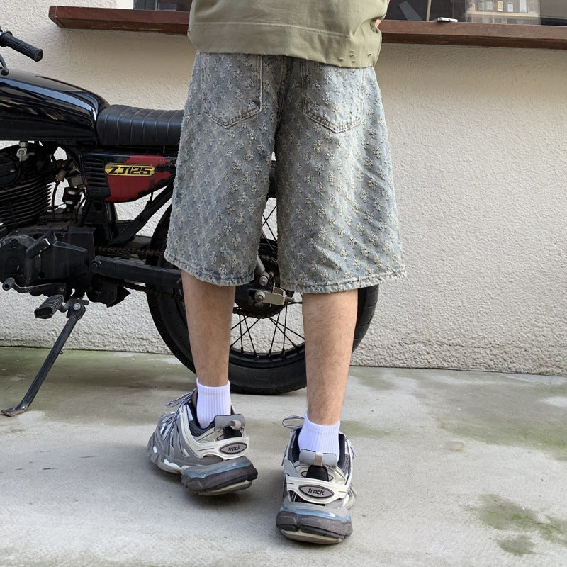 Light blue five-point denim shorts with speckled pattern, cuffed relaxed leg