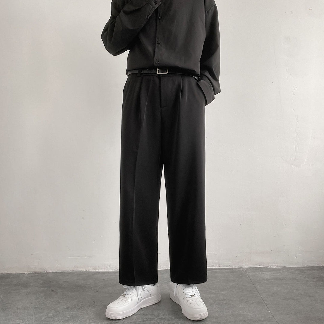 Men's black wide-leg straight trousers with belt loops and relaxed fit