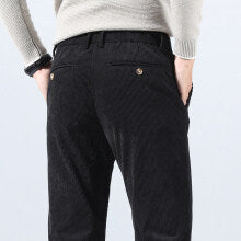 Black corduroy trousers with belt loops and small front coin pocket