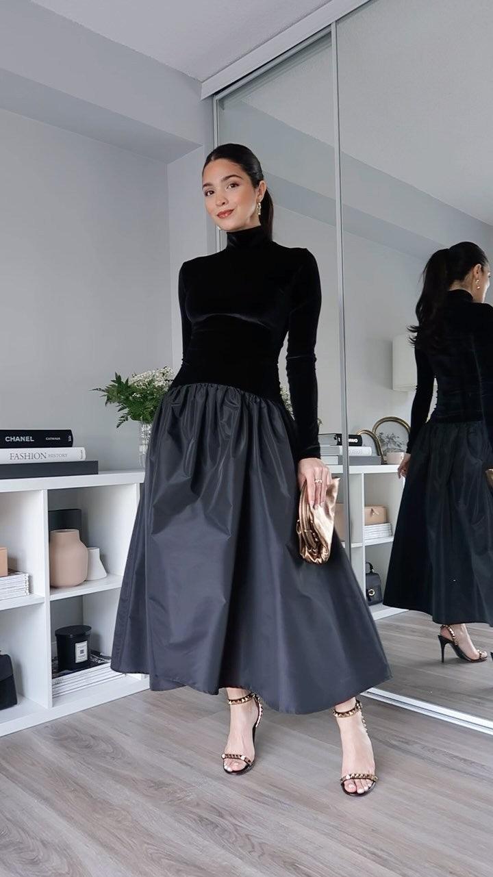 Black long-sleeve velvet high neck dress with gathered midi skirt, side view
