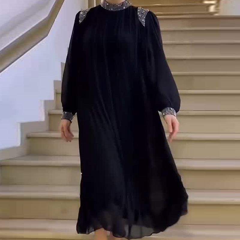 Black long dress with embellished high neckline and long sleeves, flowing hem