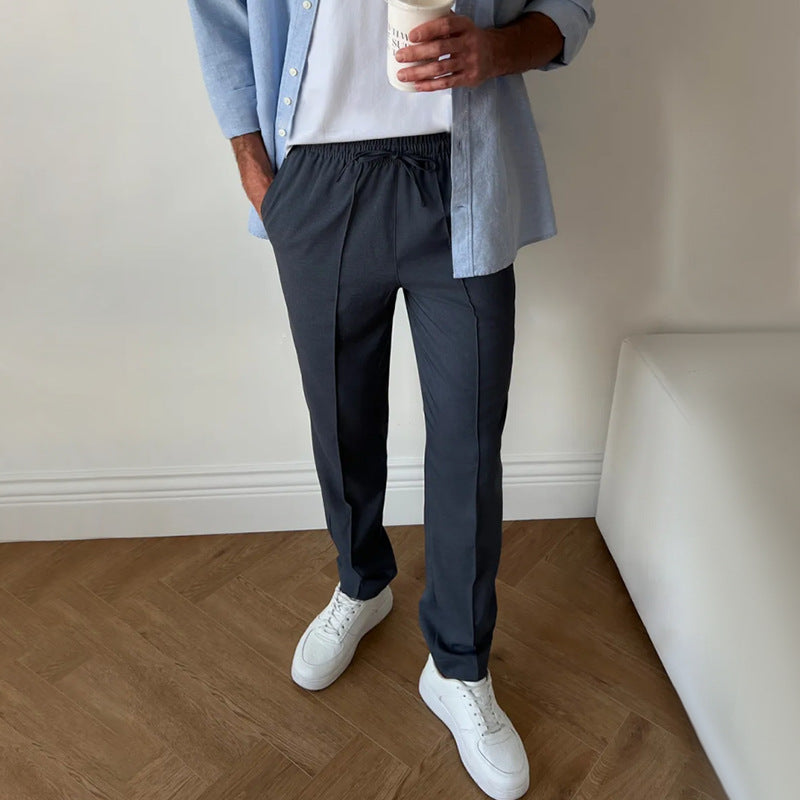 Men's pleated twill slim-fit tapered pants with elastic waist, dark navy