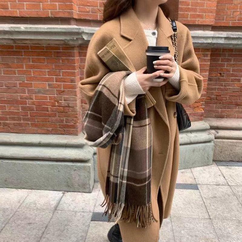 Women’s mid-length camel brown wool trench coat with notched lapels and double row buttons
