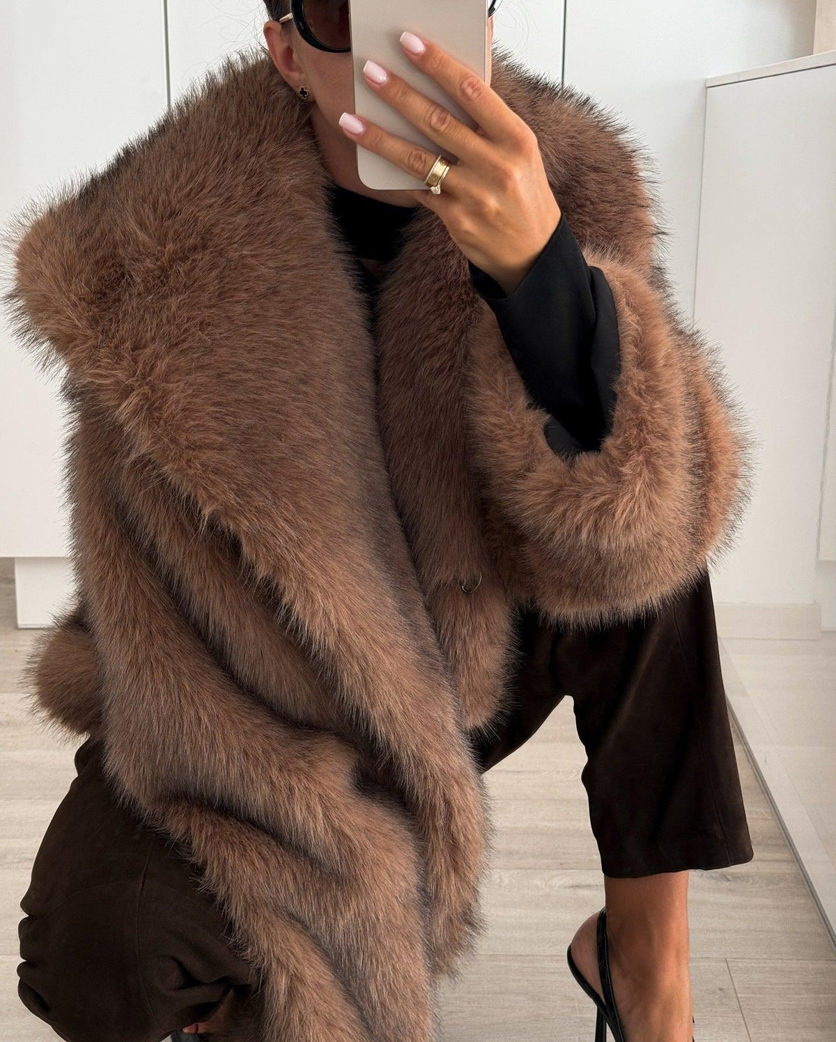 Brown plush faux-fur coat with oversized collar, long sleeves, side hem visible