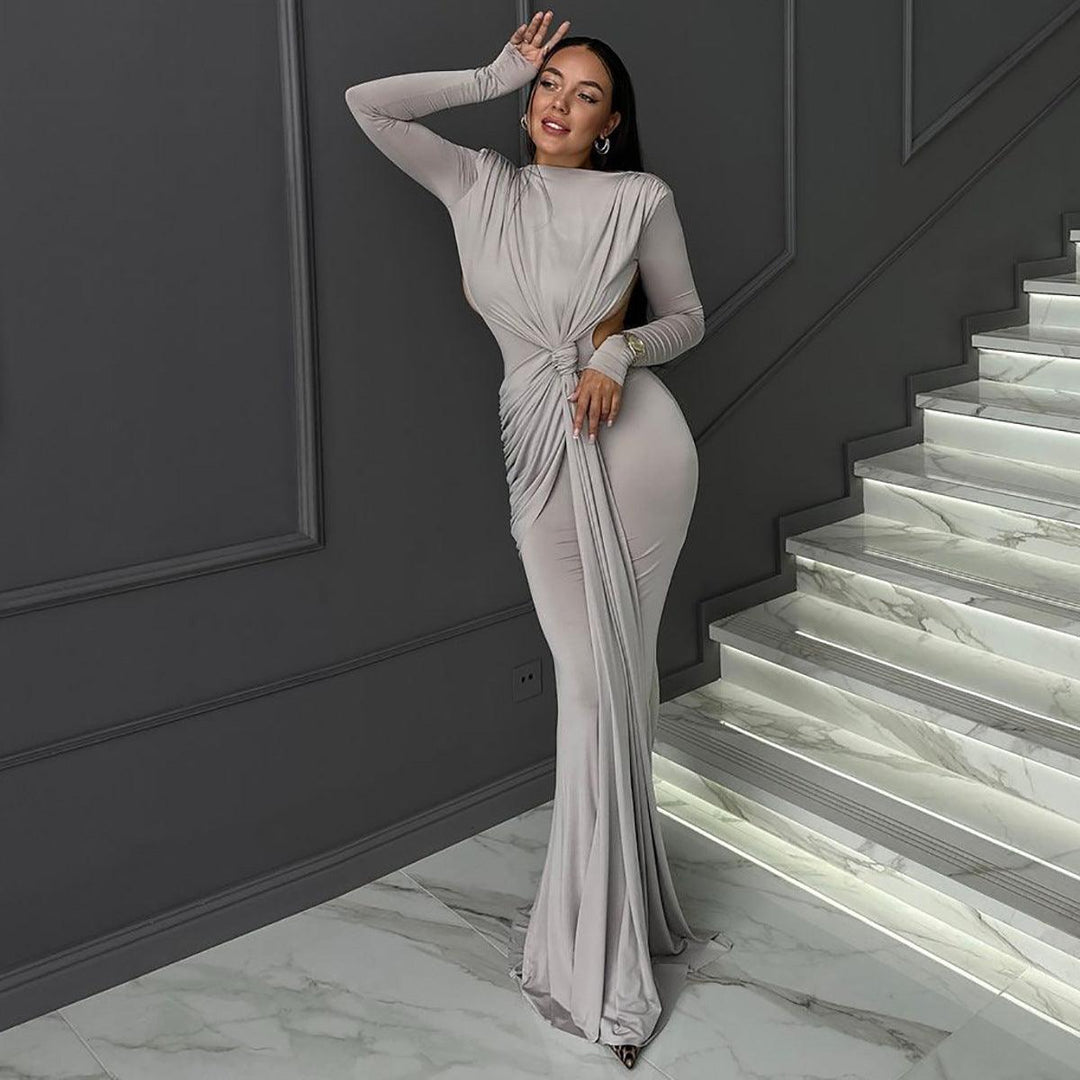 Light gray long-sleeve maxi dress with ruched waist knot and fitted, flared hem.