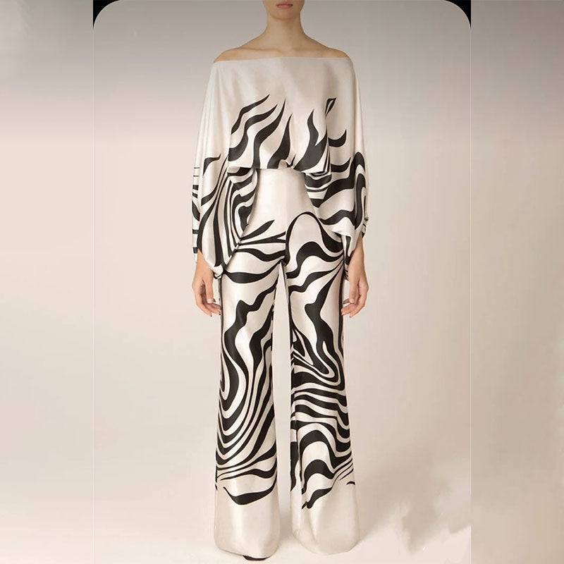 White wide-leg pants with bold black abstract swirl print.