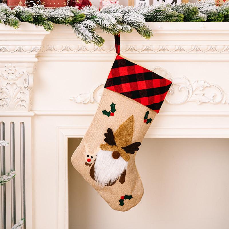 Beige Christmas stocking with red-and-black plaid top, reindeer and snowman patches