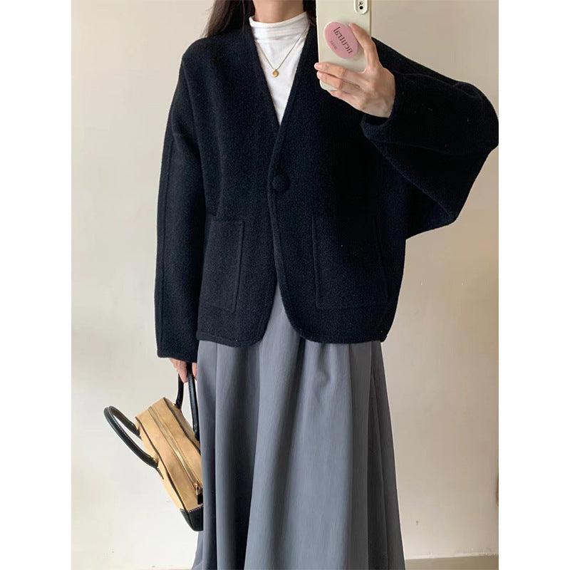 Navy-black button-front wool coat with round neckline and front patch pockets