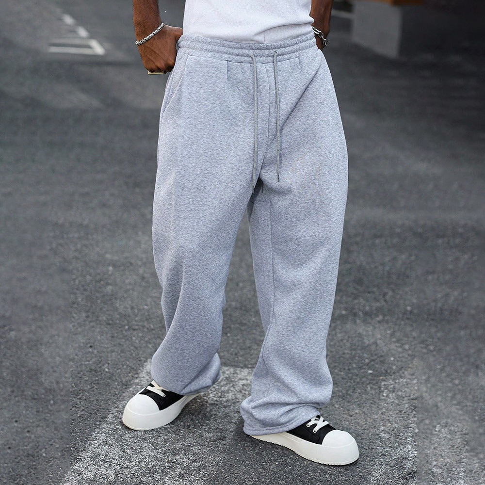 Light gray elastic-waist sweatpants with drawstring, roomy straight-leg fit.