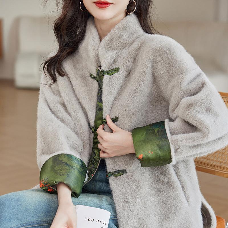 Beige faux fur Chinese-style coat with green toggle buttons and fitted cuffs