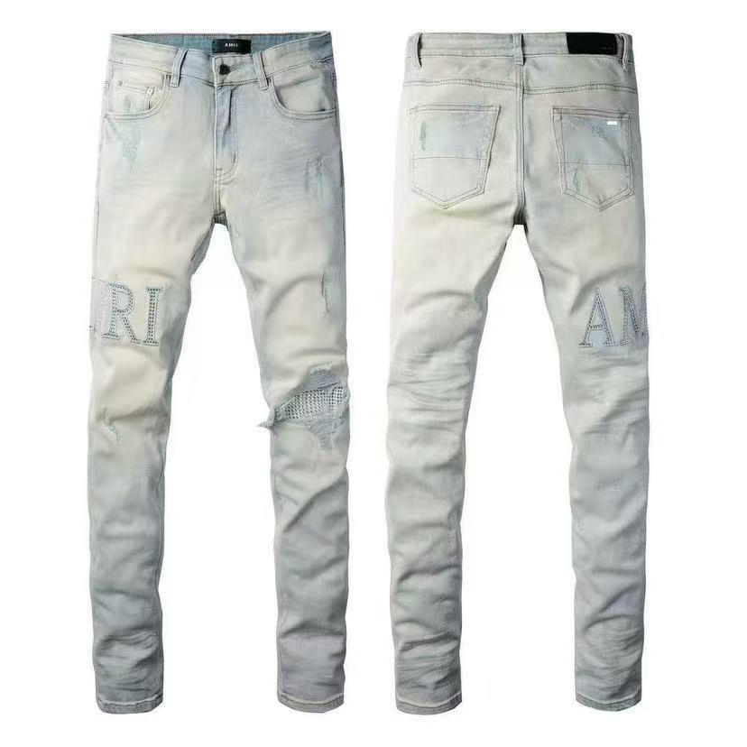 Men's slim jeans in light wash with subtle graphic prints and back pocket detailing